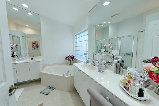 bathroom featuring vanity, tile patterned flooring, and plus walk in shower