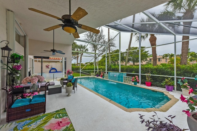 view of swimming pool featuring an outdoor living space, pool water feature, a patio area, and a lanai