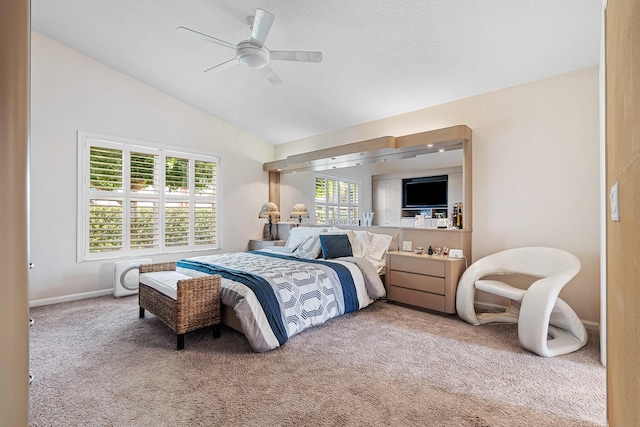 bedroom featuring ceiling fan, carpet flooring, lofted ceiling, and multiple windows