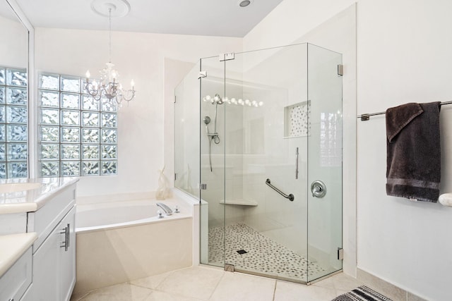 bathroom with vanity, tile patterned flooring, and plus walk in shower