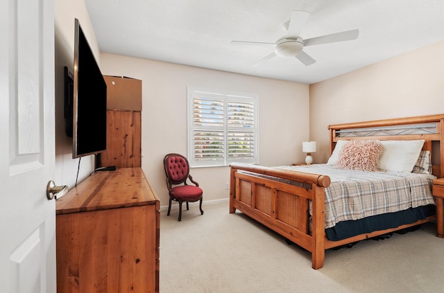 bedroom with light carpet and ceiling fan