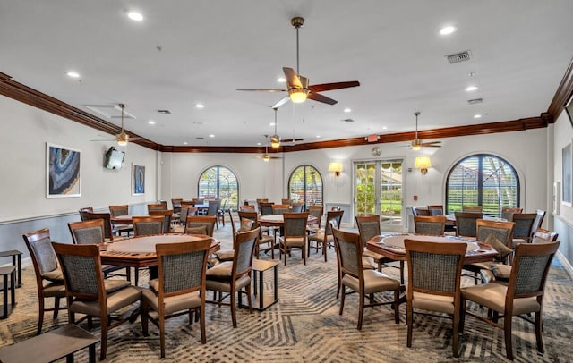 dining space with ornamental molding and carpet