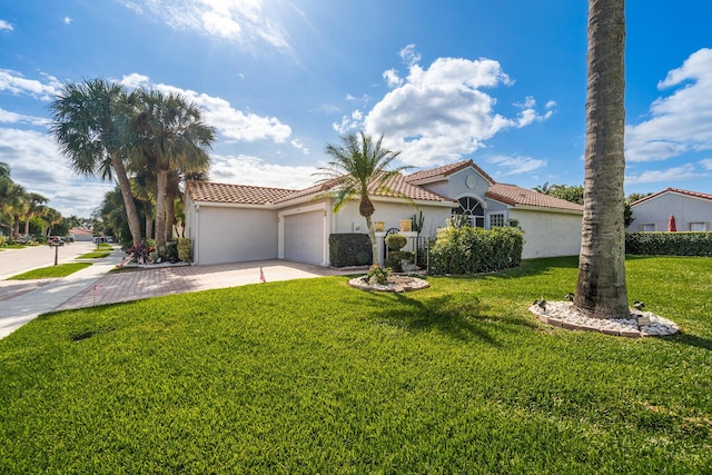 mediterranean / spanish-style house with a front yard and a garage