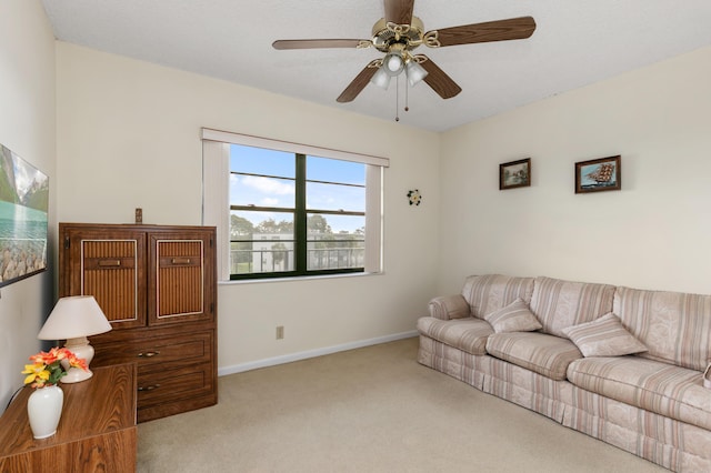 carpeted living room featuring ceiling fan