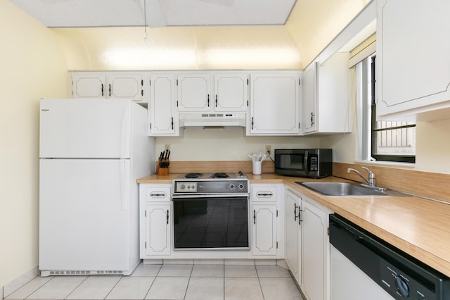 kitchen with light tile patterned floors, white cabinetry, sink, and white appliances