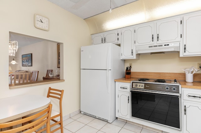 kitchen with white cabinets, light tile patterned floors, white refrigerator, and electric range oven