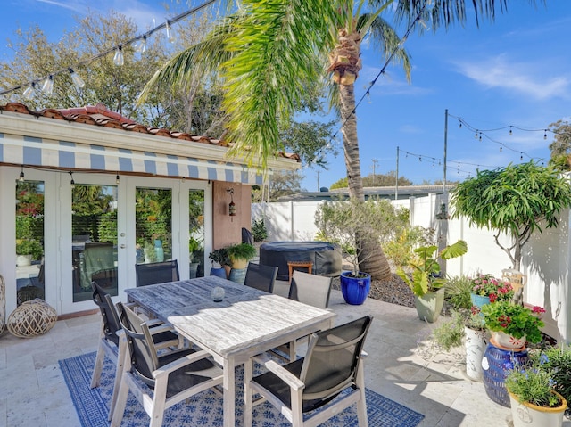 view of patio / terrace featuring a hot tub and french doors