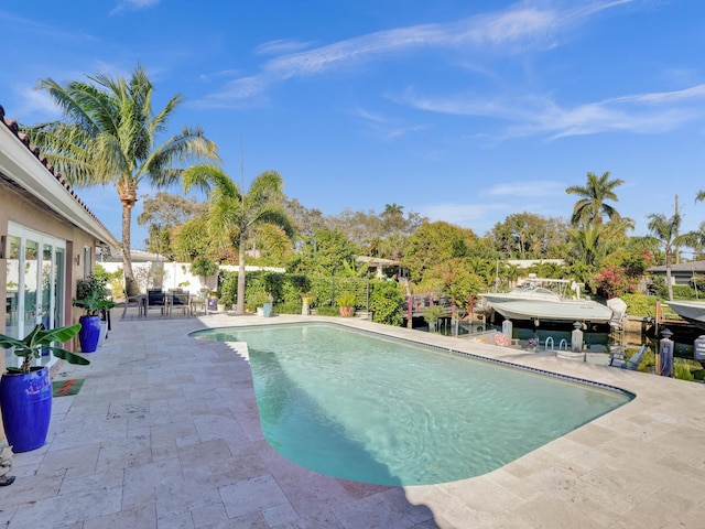 view of swimming pool with a patio area