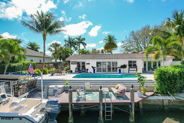 rear view of house featuring a community pool and a patio area