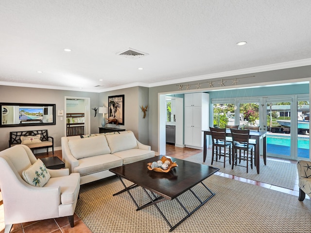 tiled living room with ornamental molding and a textured ceiling