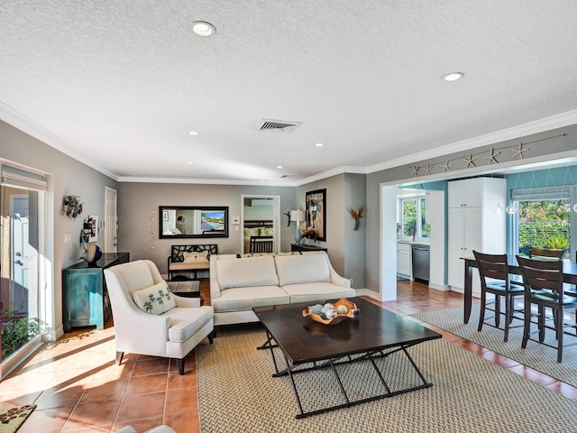 tiled living room featuring ornamental molding and a textured ceiling