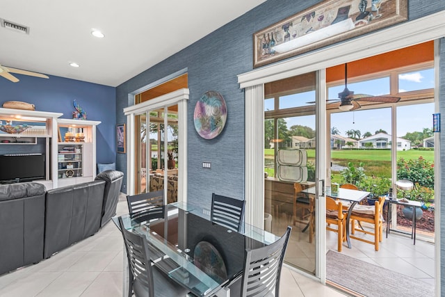 tiled dining space featuring ceiling fan