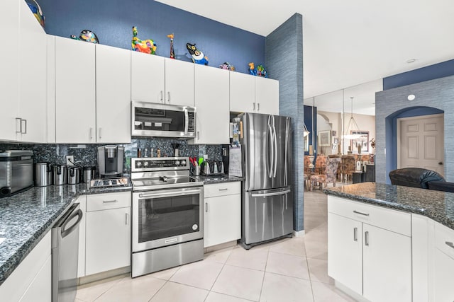 kitchen featuring light tile patterned floors, white cabinetry, and appliances with stainless steel finishes