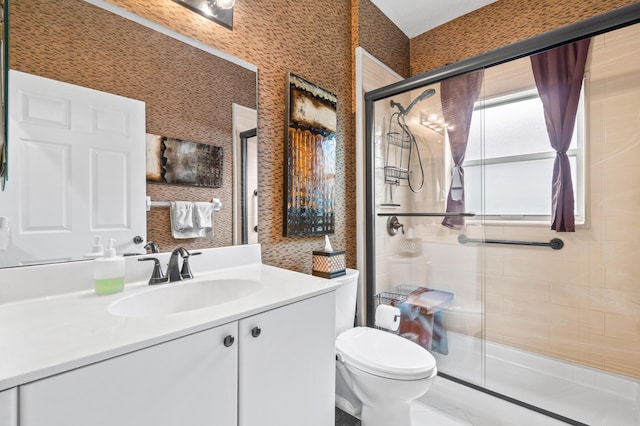 bathroom featuring vanity, toilet, an enclosed shower, and tile patterned flooring