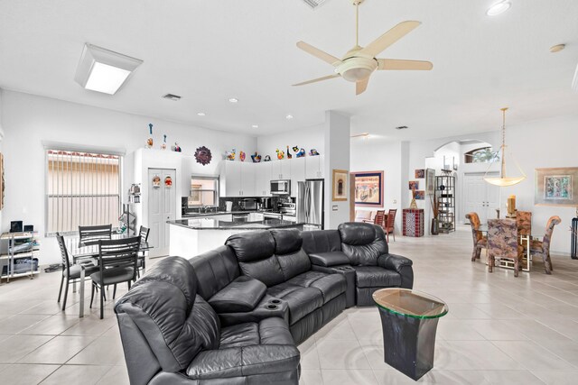 living room with ceiling fan and light tile patterned flooring