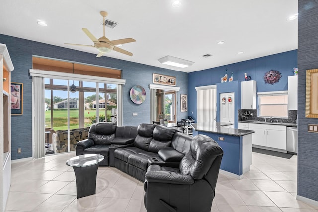 tiled living room featuring sink and ceiling fan