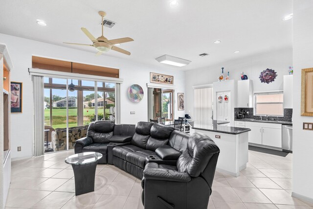 tiled living room featuring ceiling fan