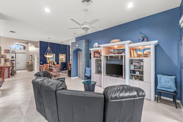 living room featuring light tile patterned flooring, built in features, and ceiling fan