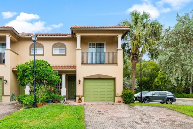 mediterranean / spanish-style home featuring a garage and a balcony