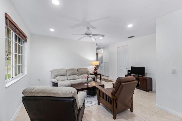 living room with ceiling fan and light tile patterned flooring