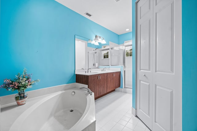 bathroom featuring tile patterned floors, separate shower and tub, and vanity