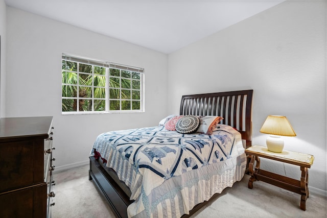 bedroom featuring light colored carpet