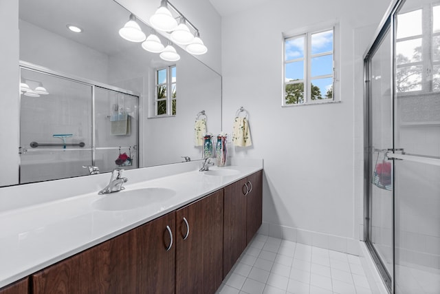 bathroom with tile patterned flooring, a shower with shower door, and vanity