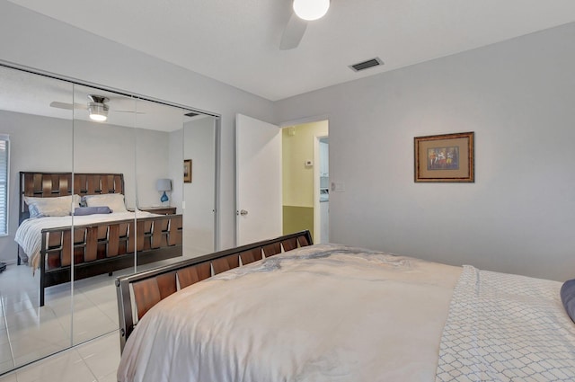 tiled bedroom featuring a closet and ceiling fan