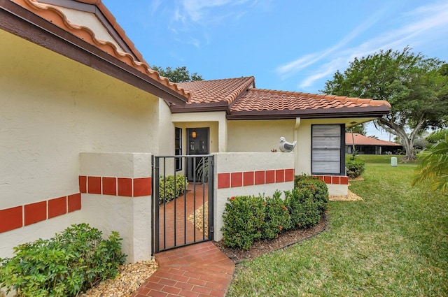 doorway to property featuring a lawn