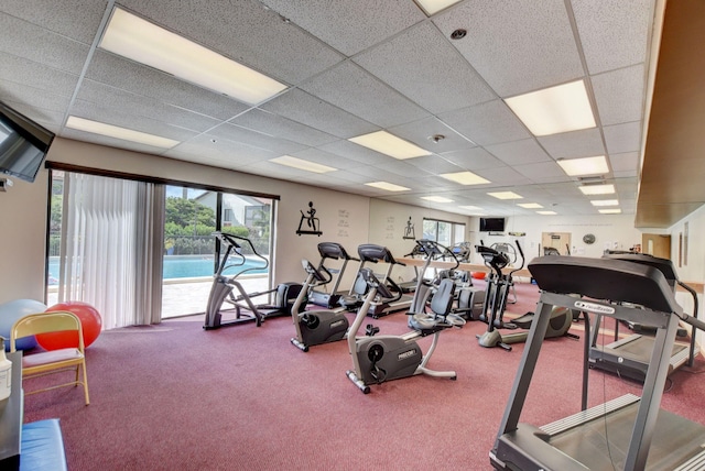 workout area with carpet flooring and a drop ceiling