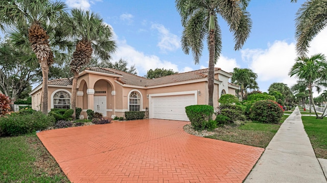 mediterranean / spanish house with a garage