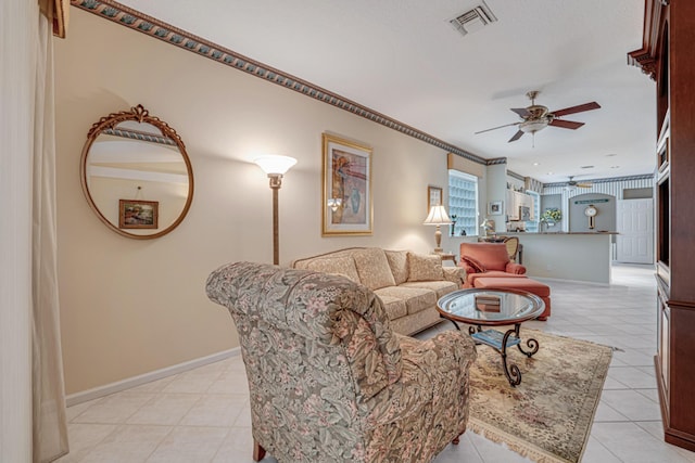 living room with ceiling fan and ornamental molding