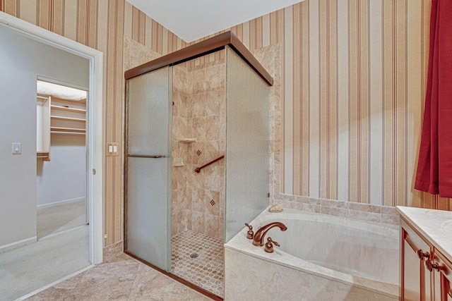 bathroom featuring vanity and independent shower and bath