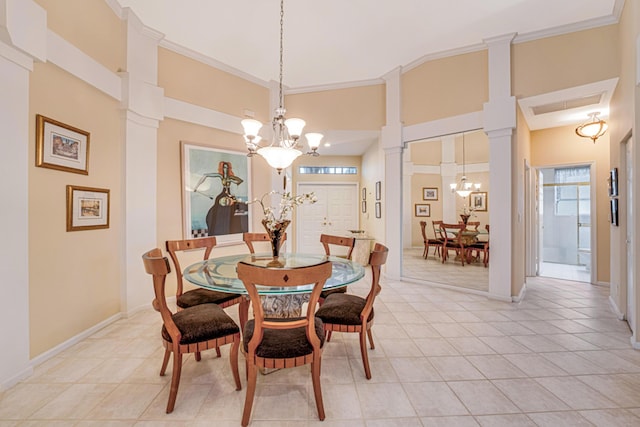 tiled dining space featuring an inviting chandelier, ornamental molding, and decorative columns