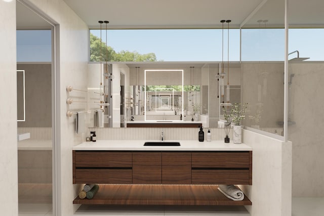 bathroom with a shower, a wealth of natural light, and vanity