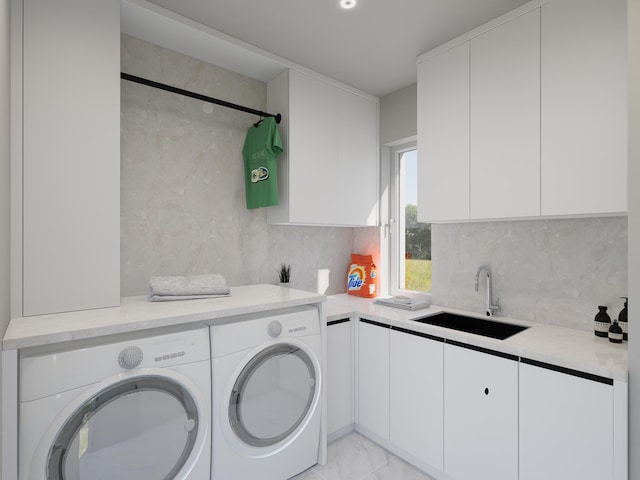 clothes washing area with cabinets, sink, and washing machine and dryer