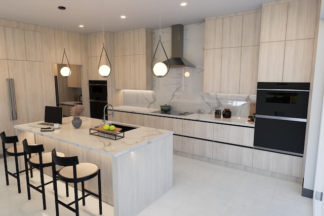 kitchen with black appliances, light stone countertops, a kitchen island with sink, wall chimney range hood, and light brown cabinets