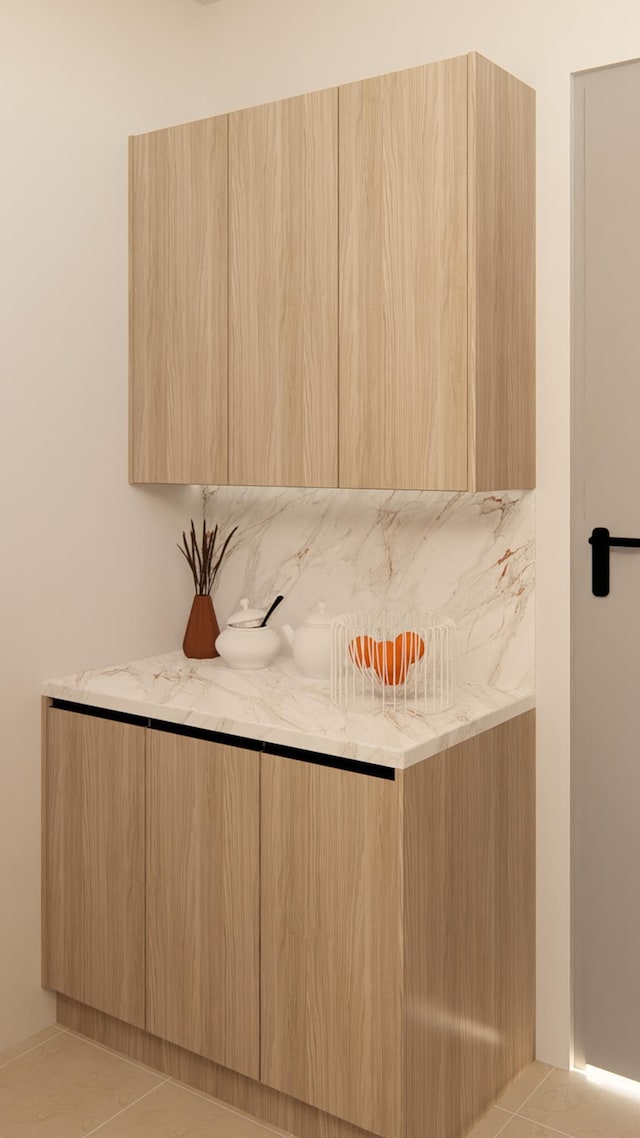 bar with light brown cabinetry and light tile patterned floors