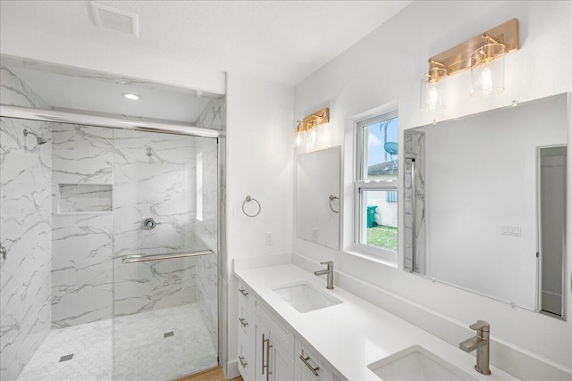 bathroom with walk in shower and vanity