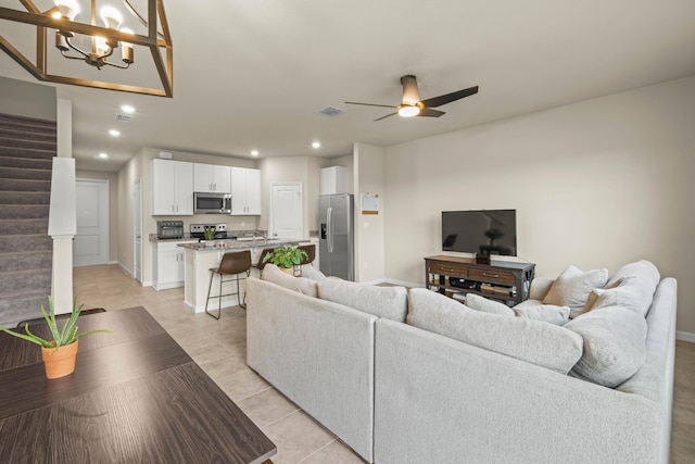 tiled living room with ceiling fan