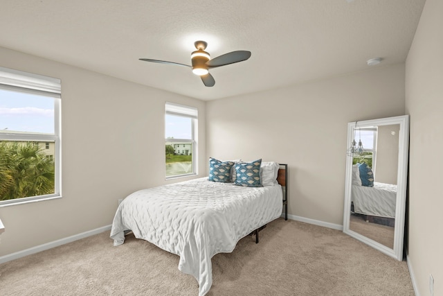 bedroom featuring ceiling fan and light colored carpet