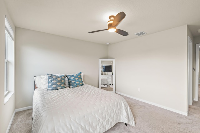 bedroom with ceiling fan and light colored carpet