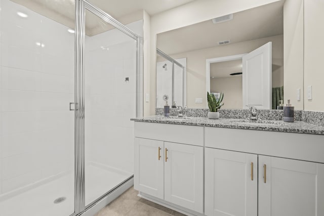 bathroom featuring a baseboard heating unit, an enclosed shower, vanity, and tile patterned flooring