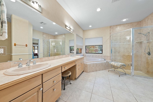 bathroom featuring shower with separate bathtub, a textured ceiling, tile patterned flooring, and vanity