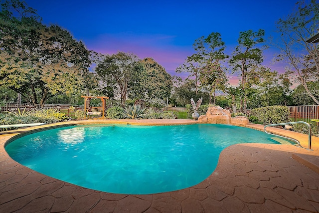 pool at dusk featuring a fenced in pool, a fenced backyard, and a patio