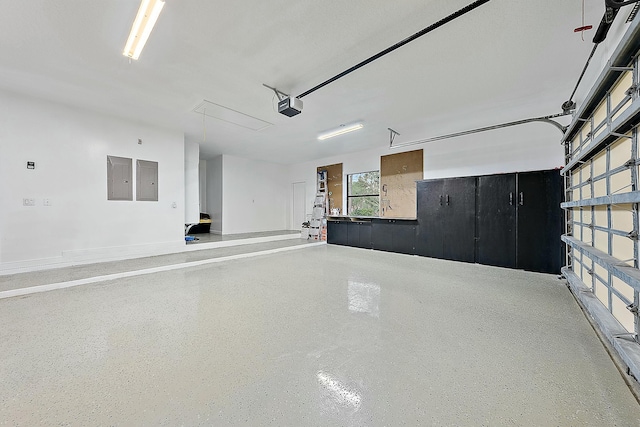 garage with electric panel and a garage door opener