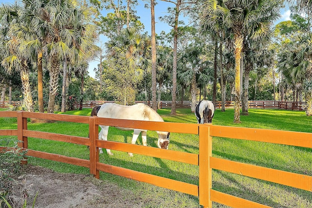 view of gate featuring a rural view and a yard