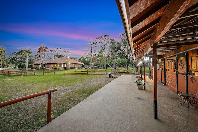 yard at dusk featuring an exterior structure
