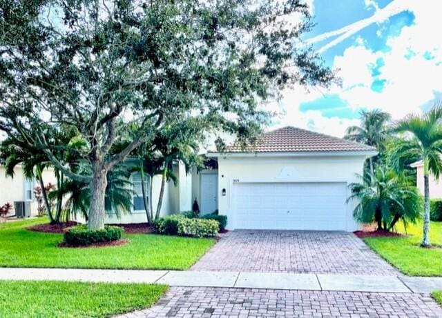 view of front of home with a garage and a front yard