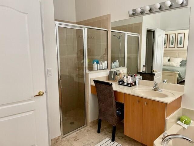 bathroom featuring an enclosed shower and vanity